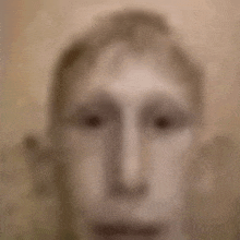 a blurry picture of a man 's face with a very large nose .