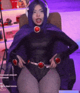 a woman in a raven costume sitting in a chair