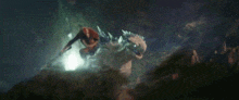 a man is riding on the back of a giant monster