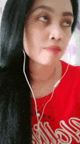 a woman wearing headphones and a red shirt that says california on it