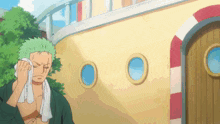 a cartoon character with green hair is wiping his face with a towel