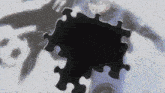 a puzzle with a shadow of a man in the background