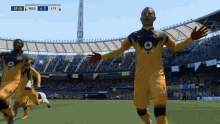 a soccer game is being played in a stadium sponsored by vodafone