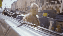 a woman is sitting in the back seat of a car