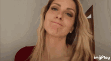 a close up of a woman 's face with the words imgplay visible