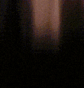 a blurry picture of a person 's face with a dark background