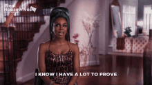 a woman in a leopard print dress is sitting in front of a sign that says real housewives
