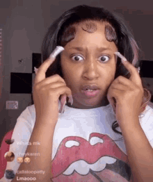 a woman wearing a rolling stones t-shirt is making a funny face with her hands .