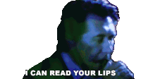 a man singing into a microphone with the words " i can read your lips " above him