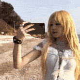 a woman is taking a picture of herself with her cell phone
