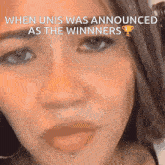 a close up of a woman 's face with a caption that says `` when unis was announced as the winners ''
