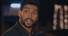 a close up of a man with a beard making a funny face .