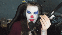 a person with a clown face painted on their face