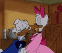 donald duck and daisy duck are kissing each other in a cartoon .