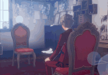 a man in a red suit is sitting in a chair
