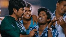 a group of men are hugging each other and one is crying