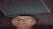 a woman with glasses and butterflies on her face is making a funny face .
