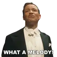a man in a tuxedo with the words what a melody written below him