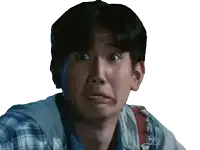 a man in a plaid shirt makes a funny face