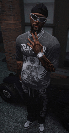 a man wearing a trap t-shirt and sunglasses