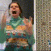a blurry picture of a woman screaming in front of a wall with a pattern