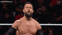 a man with a beard is standing in a wrestling ring with the hashtag thekamdreesen