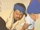 a man with a blue turban on his head is sitting next to a woman .