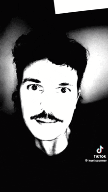 a black and white photo of a man with a mustache ..