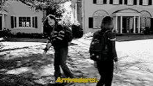 a black and white photo of two girls standing in front of a house with the words `` arrivederci '' written in yellow .