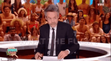 a man in a suit and tie is sitting in front of a crowd with the words what the flu written on the bottom