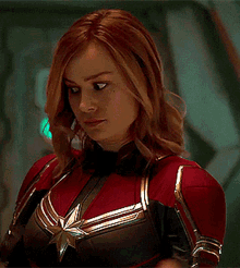a woman in a red and black superhero costume with a star on her chest