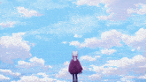 a person with a cat on their head stands in front of a blue sky with white clouds