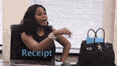 a woman is sitting at a desk with a purse and the word receipt written on it .