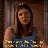 a woman in a blue tank top says there was the front of a camel a half-came