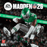 a football player in a green uniform with the number 26 on it