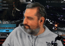 a man with a beard is sitting in front of a computer screen that says ' christian '