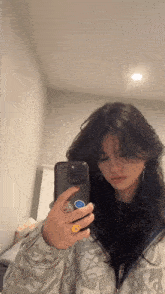 a girl is taking a selfie with her phone