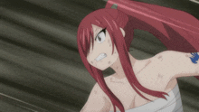 a woman with red hair and a tattoo on her arm