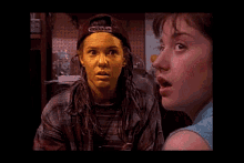 a woman with yellow paint on her face is talking to another girl .