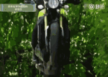 a person is riding a motorcycle with chinese writing on the bottom right