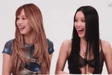 two women are laughing and one is wearing a black top