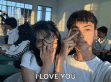 a boy and a girl in a classroom with the words i love you