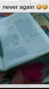 a person holding a book that says never again on it