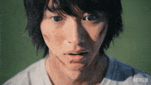 a close up of a man 's face with a netflix logo on the bottom right