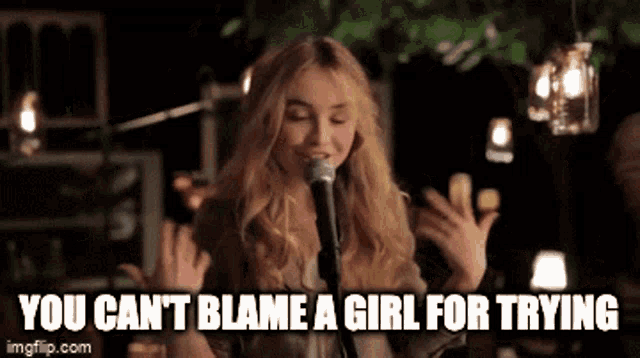 a woman singing into a microphone with the words 