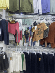 a woman is taking a picture of herself in a clothing store with a t-shirt that says eptic spy