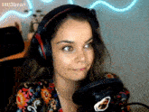 a woman wearing headphones stands in front of a microphone with litl3bean written on the bottom right