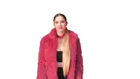 a woman wearing a pink fur coat and earrings