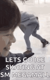 a person is ice skating at a megamall while another person looks on .
