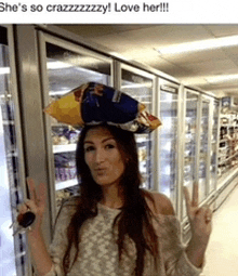 a woman wearing a bag of chips on her head is giving a peace sign